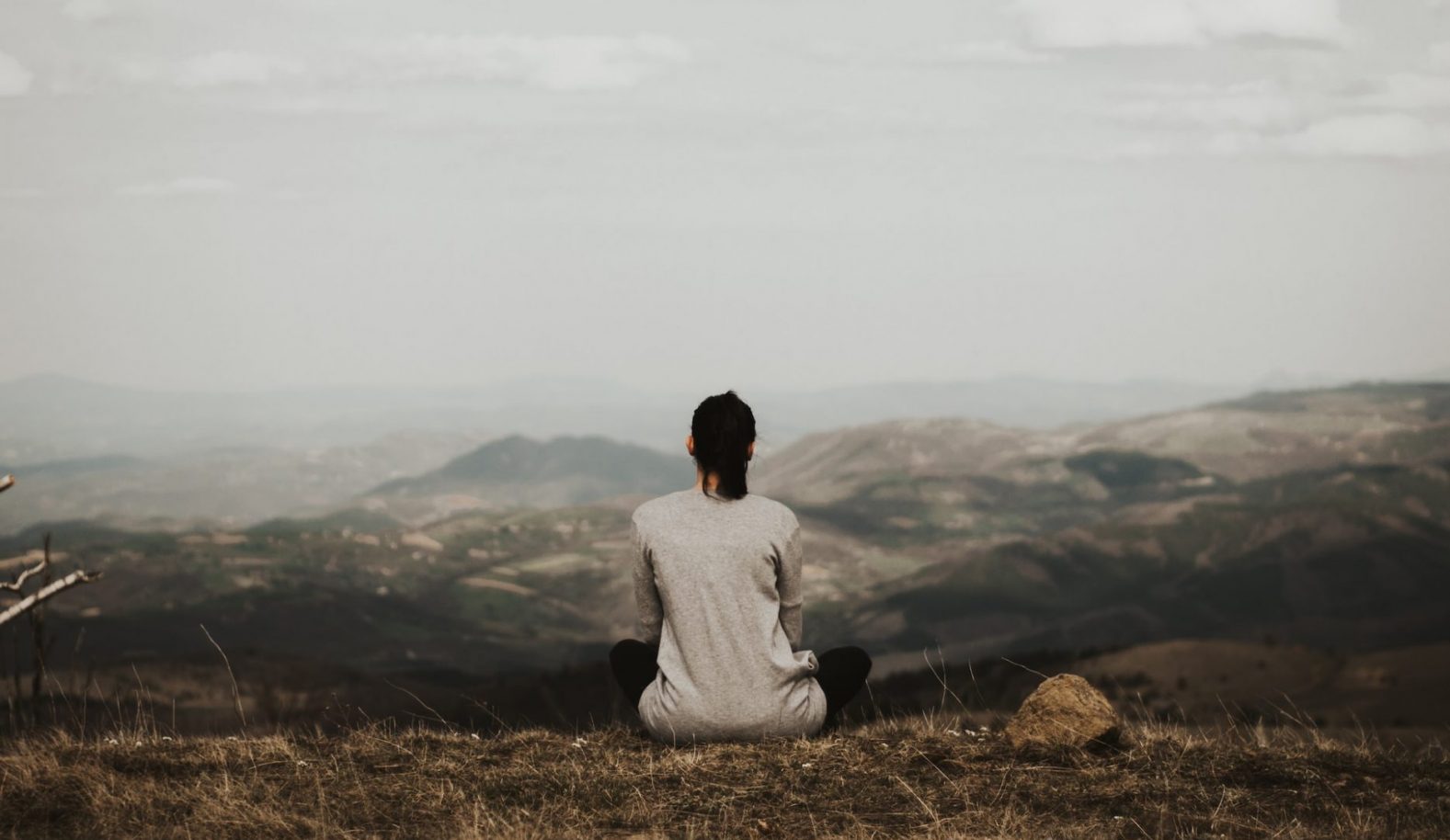 Woman sitting outside pondering