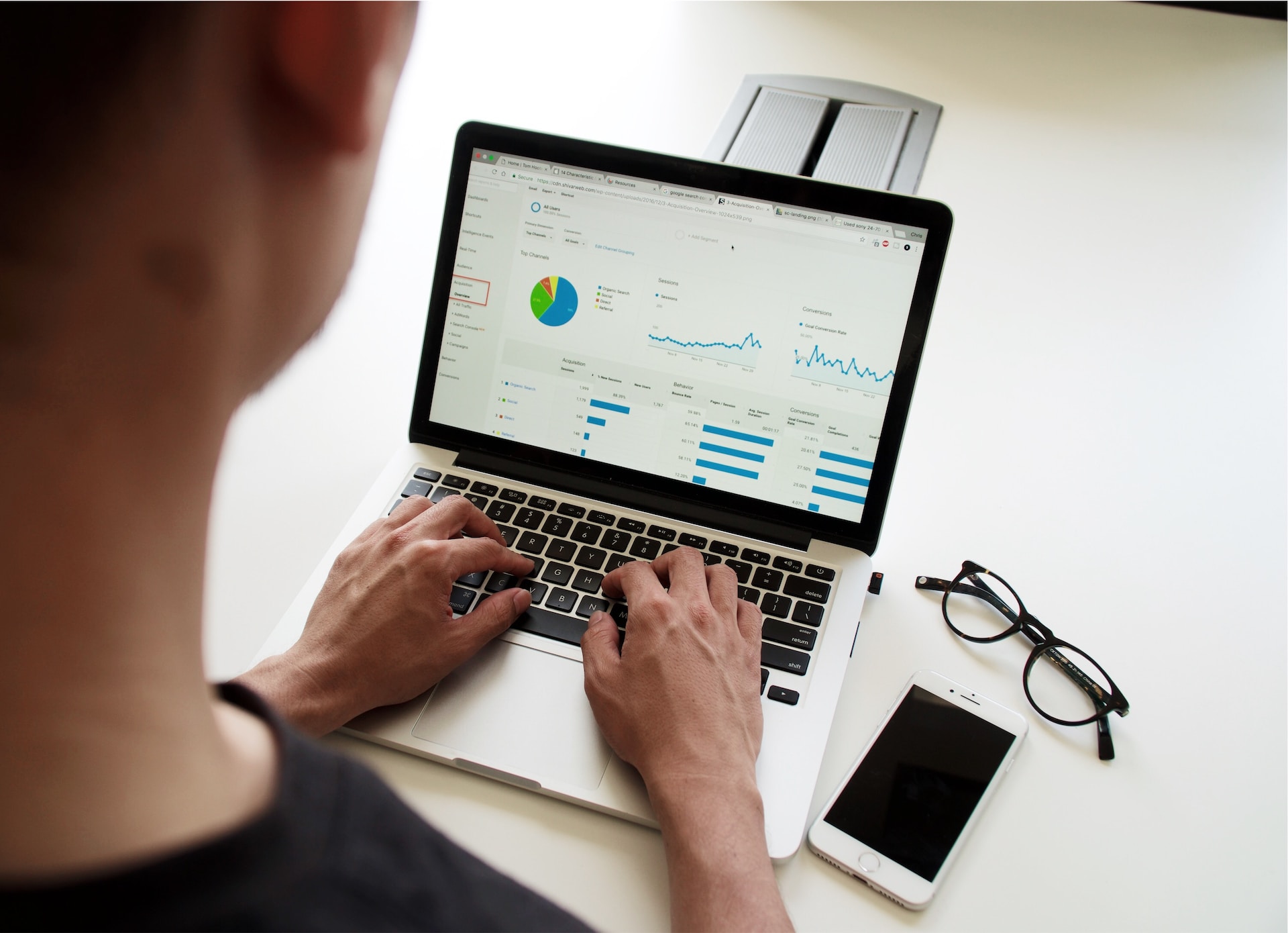 Person using a laptop to view pie charts