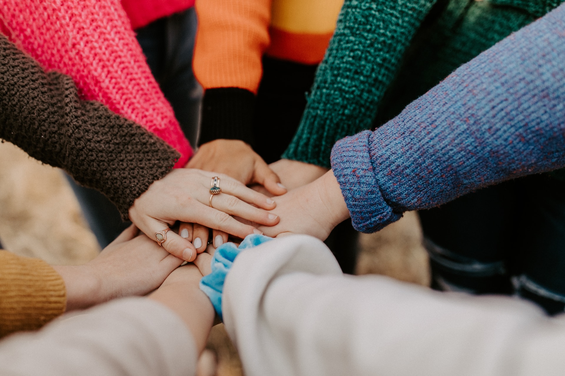 Hands in the middle in a team huddle