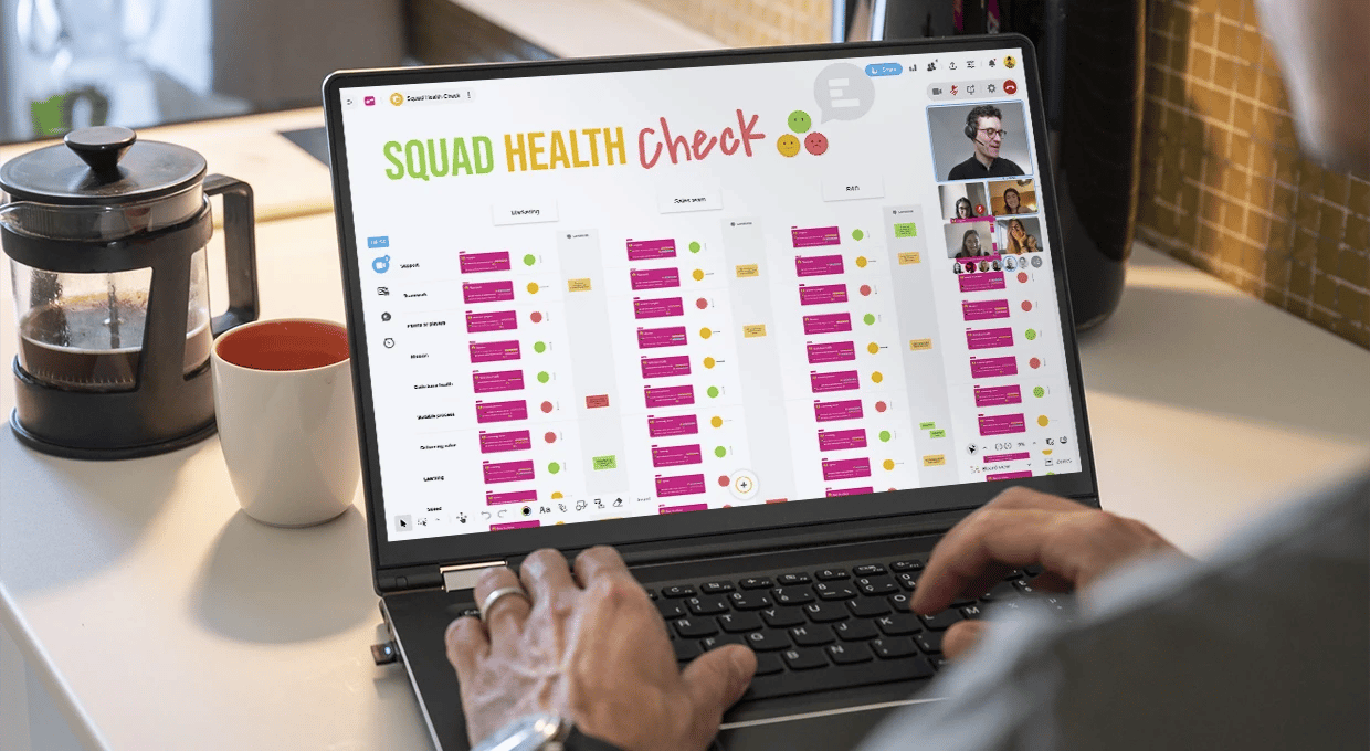 A person working on a computer and completing the Squad Health Check template on a Board with other people connected. | Klaxoon