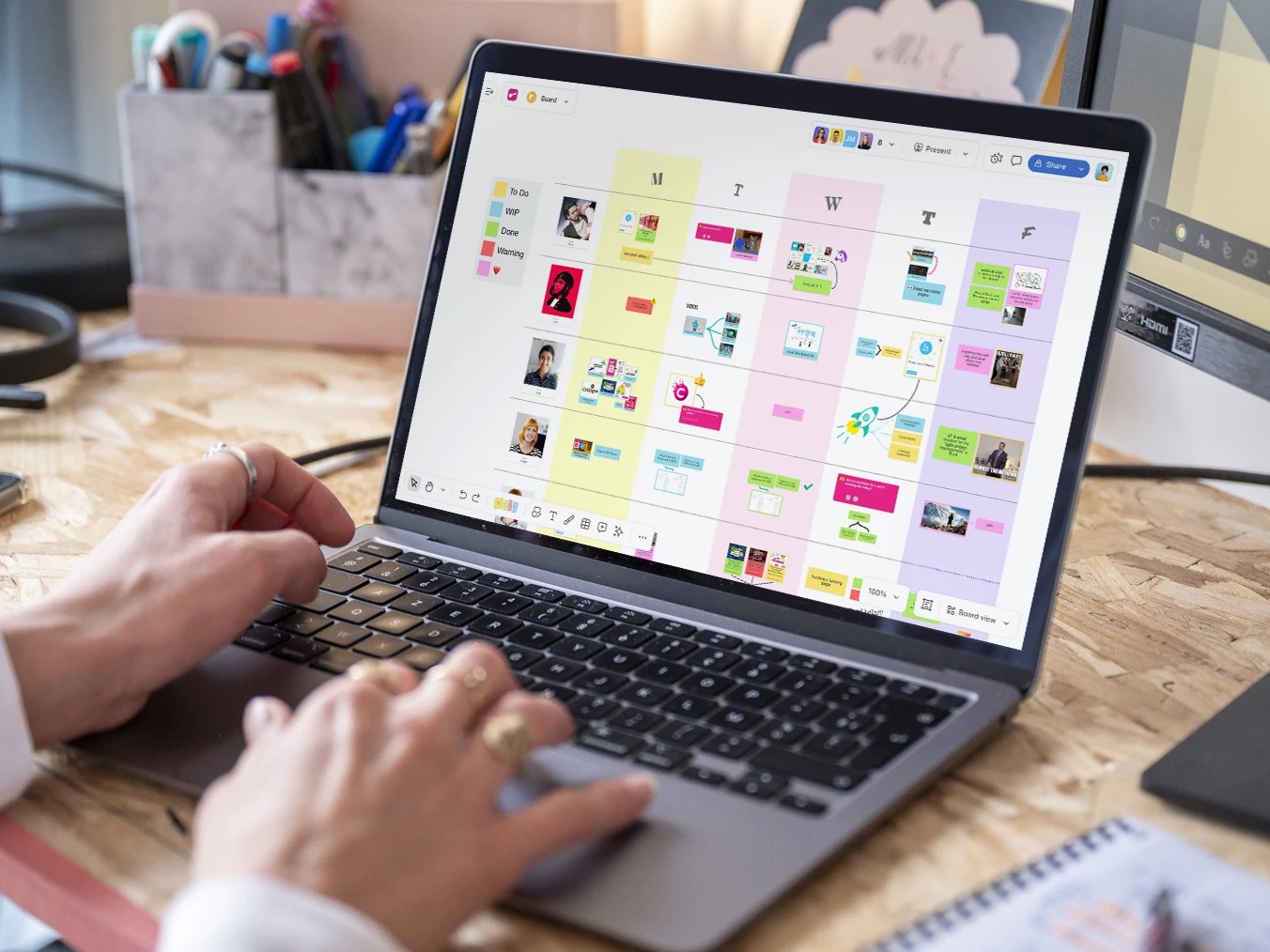Business team collaborating around laptop in office meeting.