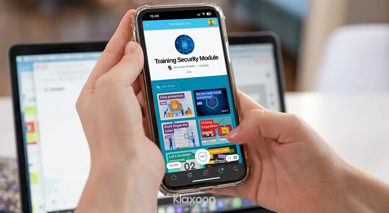 A person holding a smartphone on which a Klaxoon Network dedicated to a safety training module is open. | Klaxoon