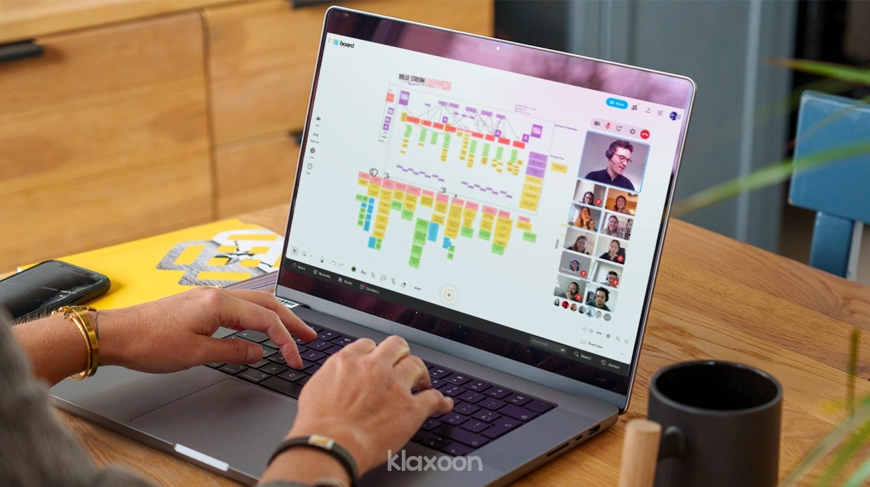 A person working remotely on a Value Stream Mapping Board with their team on a desktop. | Klaxoon
