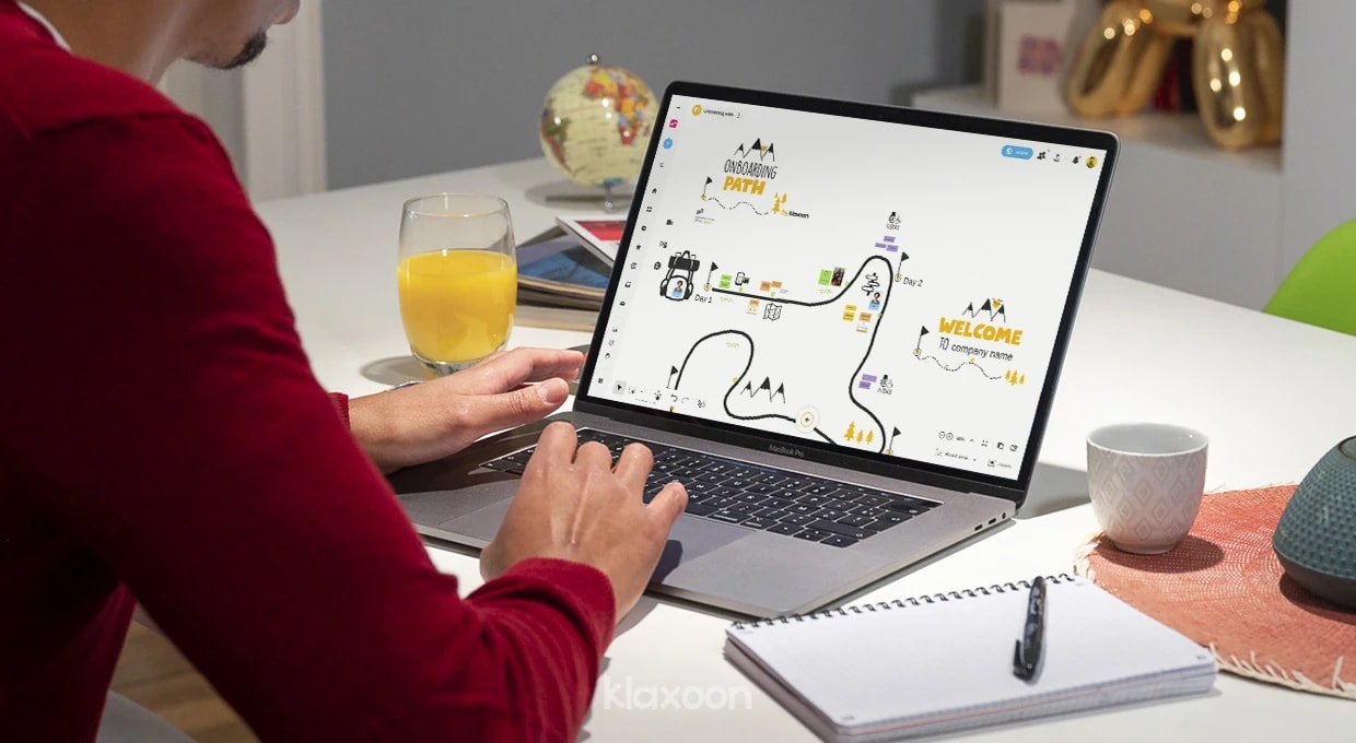 A person working on a Board displaying the Onboarding path template, with several visually defined stages and shared documents. | Klaxoon