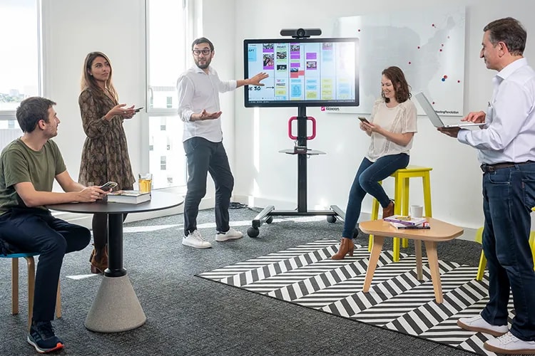 Wrike about us page showcasing platform screens and collaboration icons.