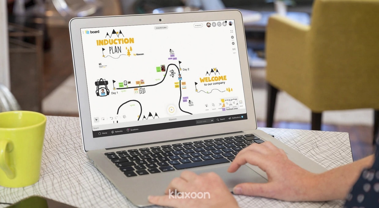 A person working on a laptop that displays an Onboarding Path template. | Klaxoon