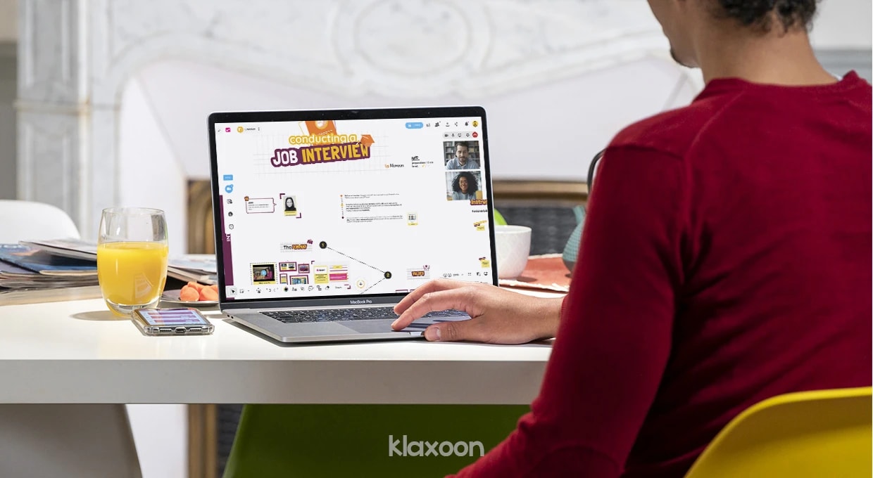 A person working remotely on a Board using the template Conducting a job interview, with two other people connected by videoconference. | Klaxoon