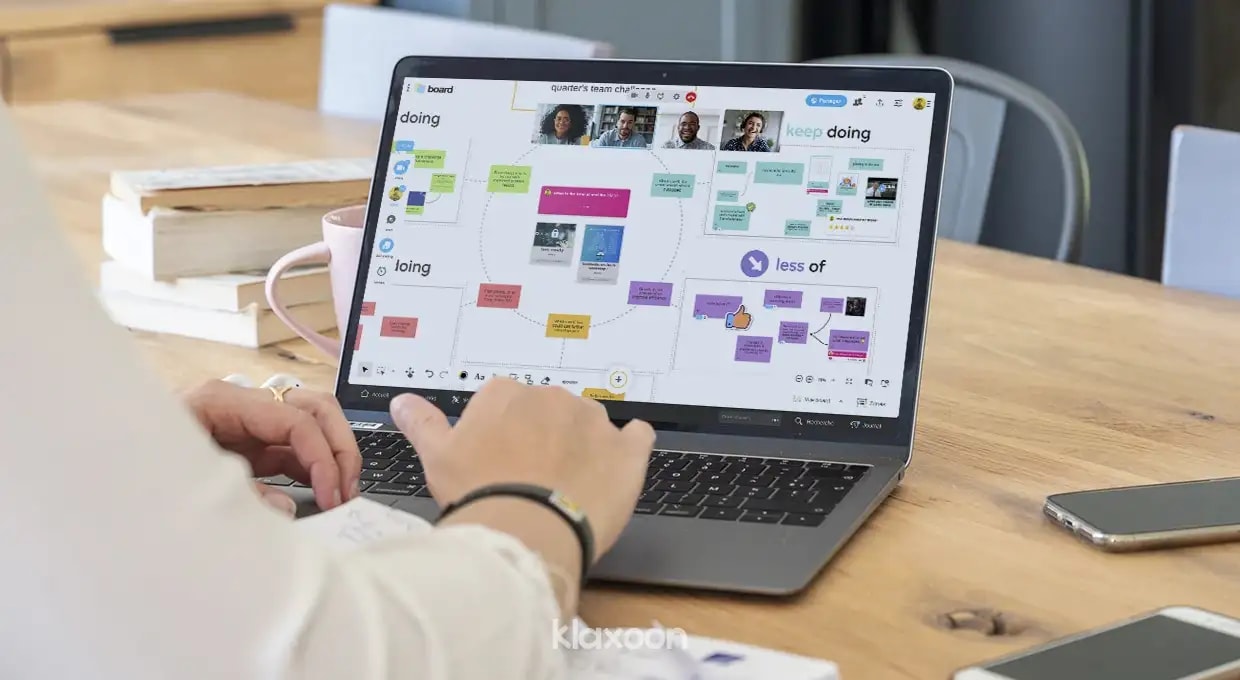 A person working on a computer displaying a Board showing several Klaxoon formats and activities combined. | Klaxoon