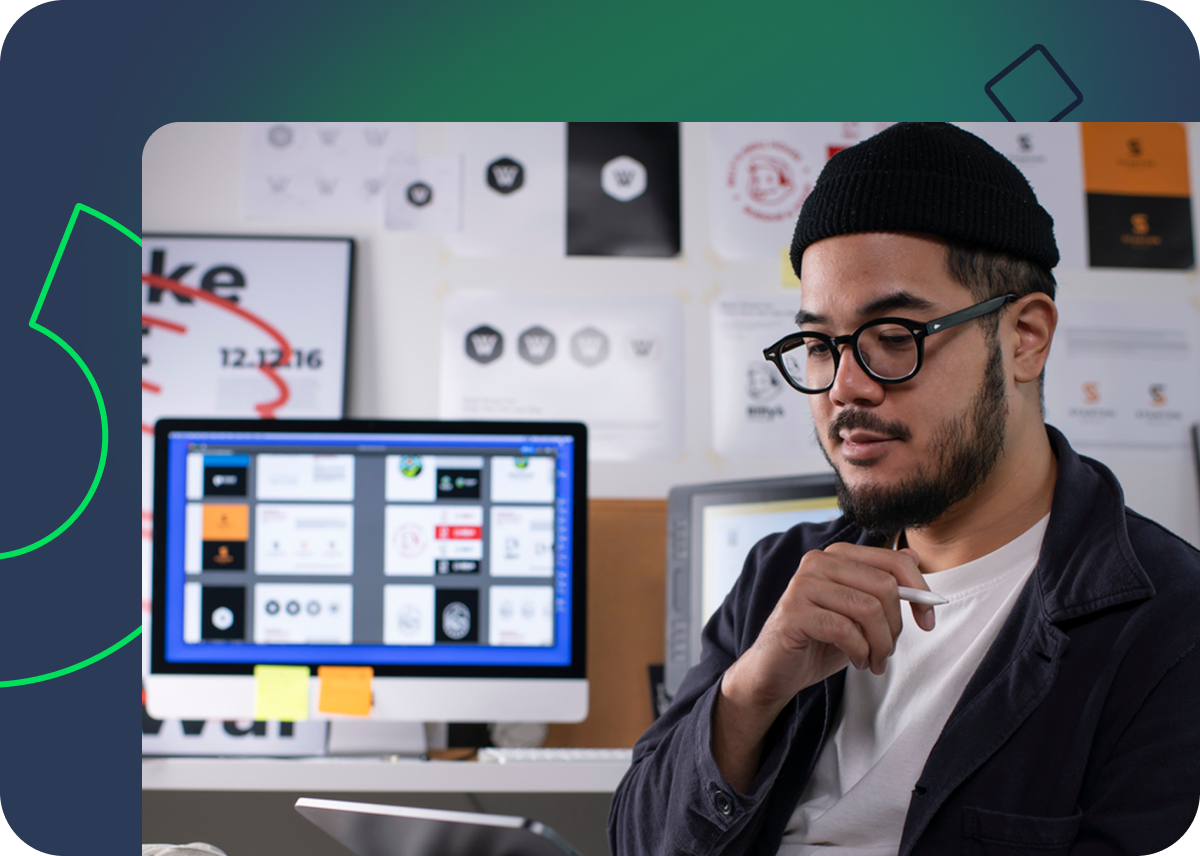 Team collaboration and project planning around table with sticky note board and laptops.