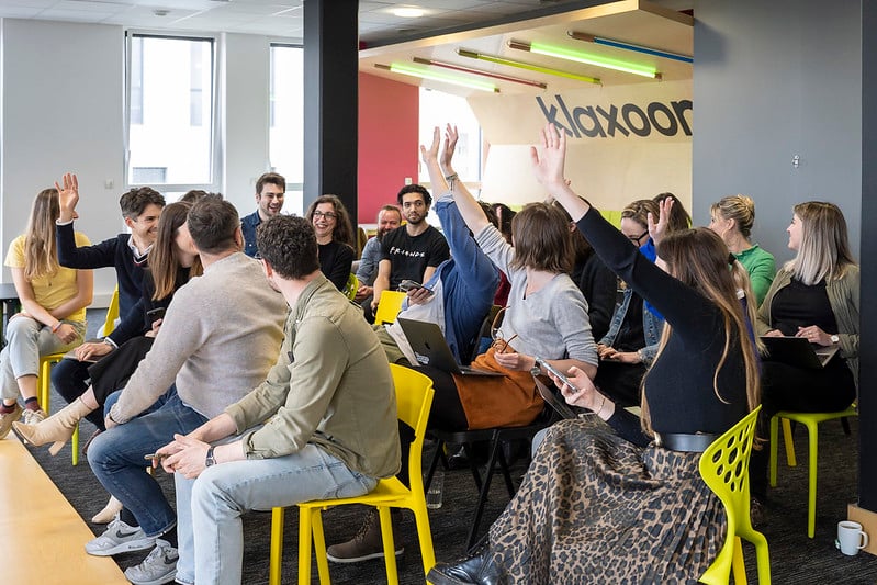 Dans une réunion de groupe, 4 personnes lèvent la main pour intervenir. | Klaxoon